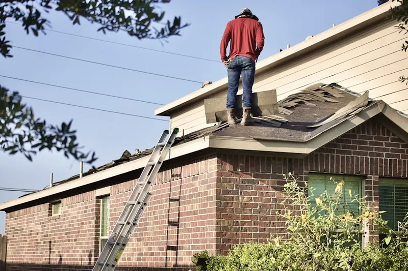 Professional roofer working on a residential roof in Roving Hills Estates